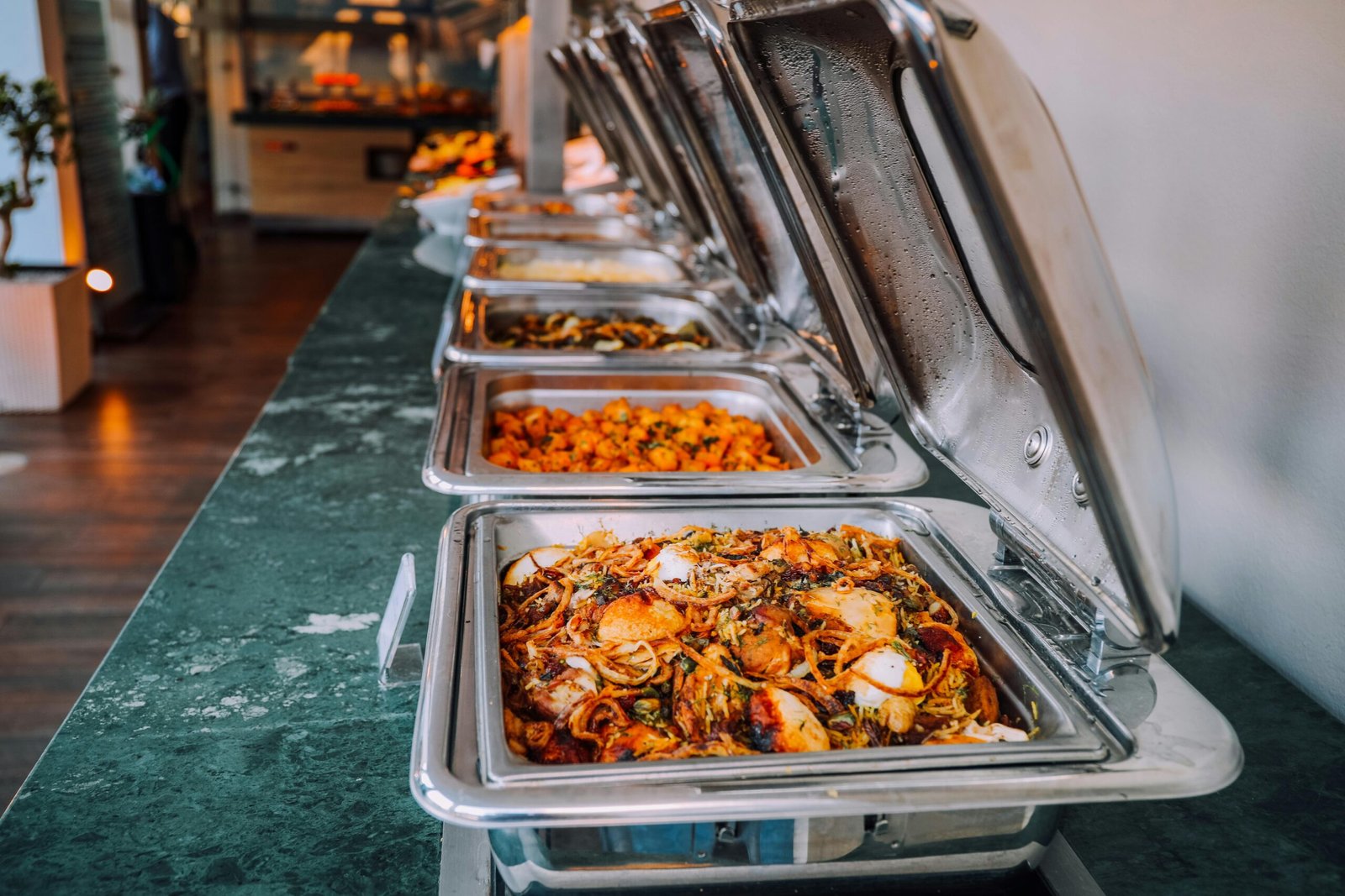 pexels-photo-2291367-2291367 An elegant buffet setup featuring various delicious dishes in stainless steel chafing dishes, perfect for events.